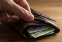 A wallet full of credit cards and cash