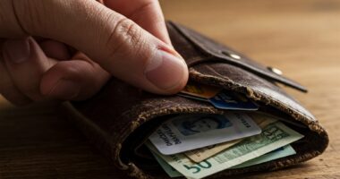 A wallet full of credit cards and cash