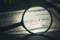 Image illustrating altered check fraud, showing a check with changes to the payee and amount.