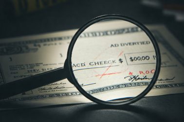 Image illustrating altered check fraud, showing a check with changes to the payee and amount.
