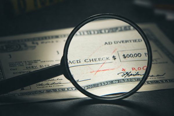 Image illustrating altered check fraud, showing a check with changes to the payee and amount.